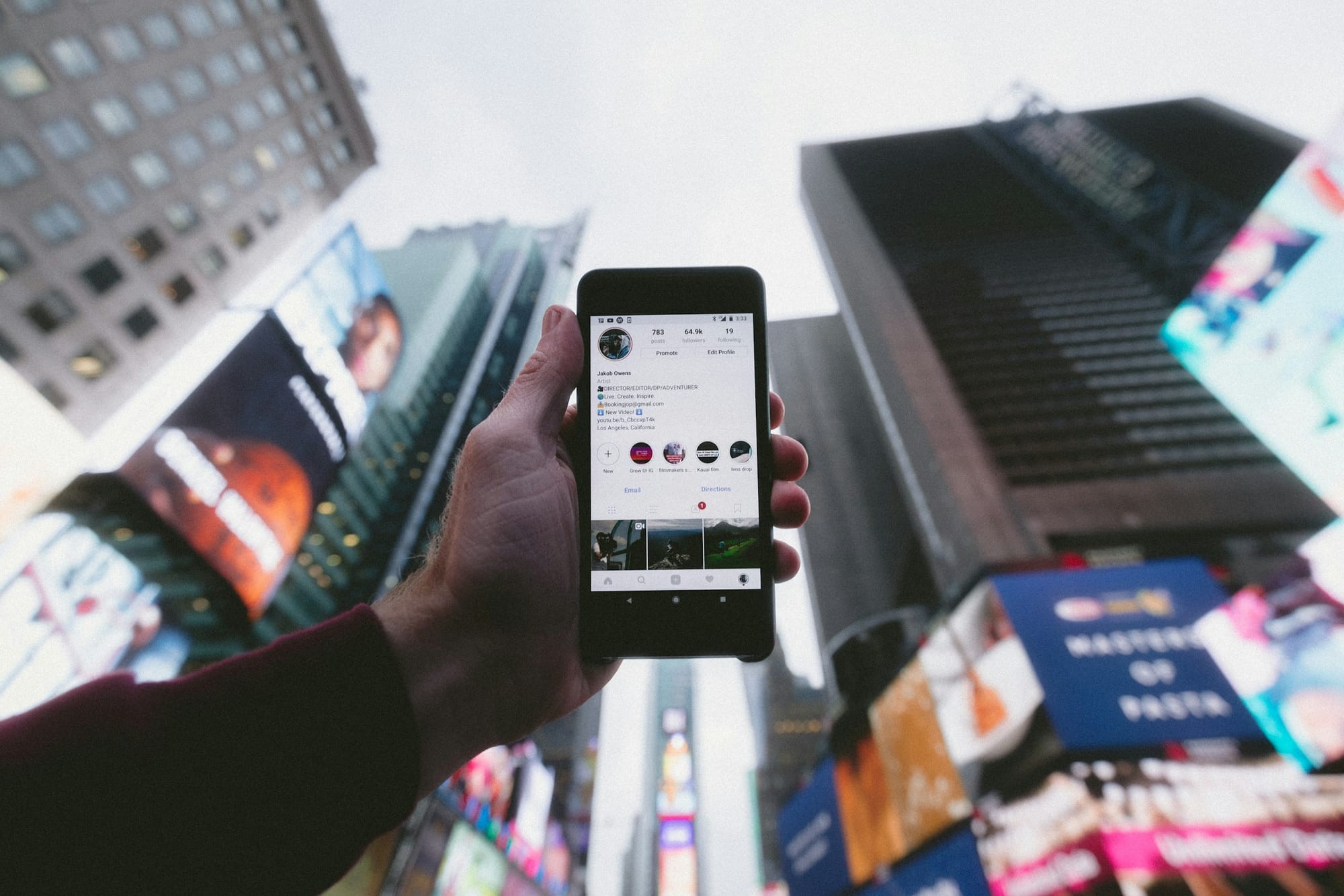 man holding phone - How To Go Viral on Instagram Reels
