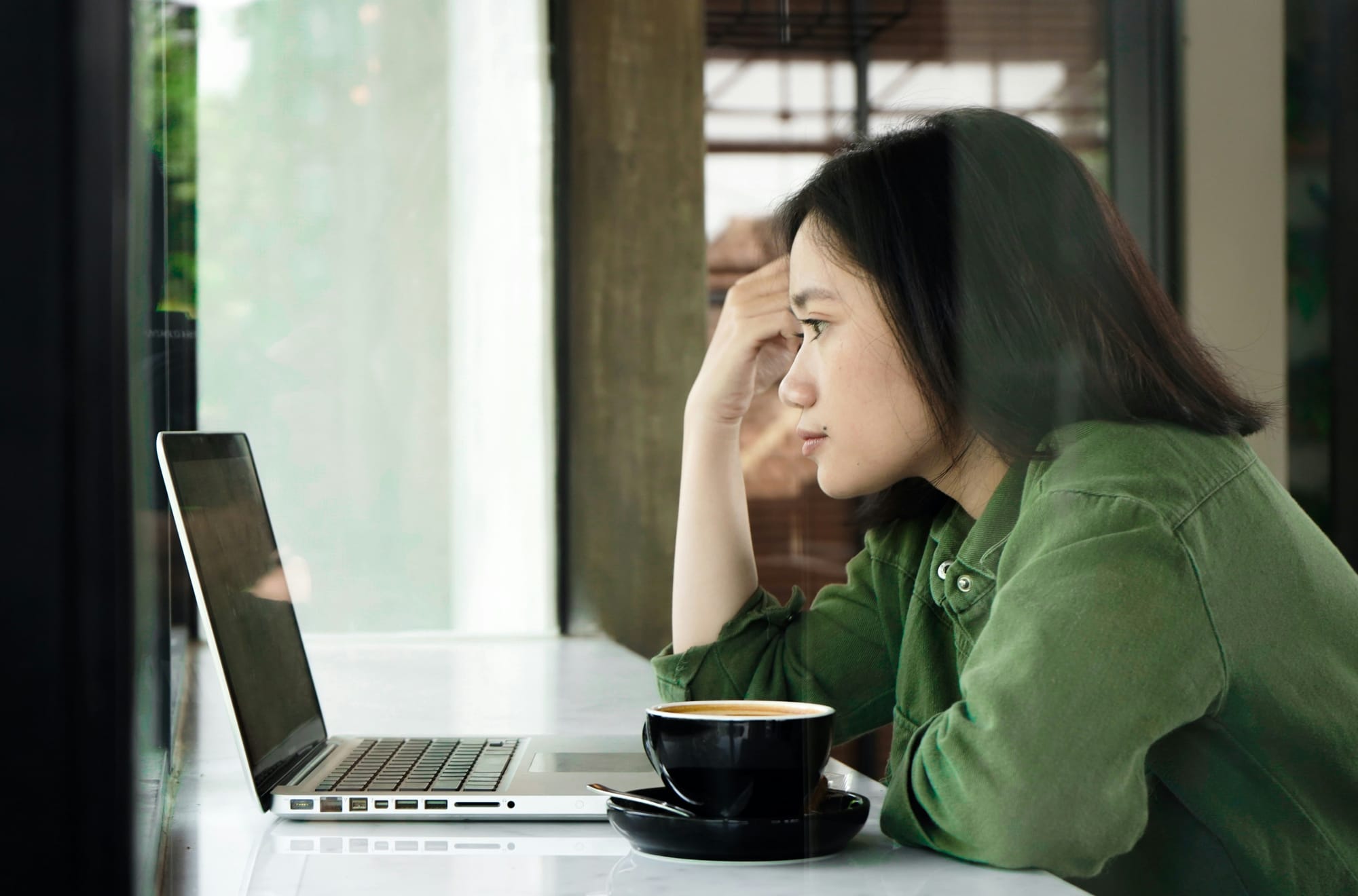 woman on a laptop - Veed vs. Descript