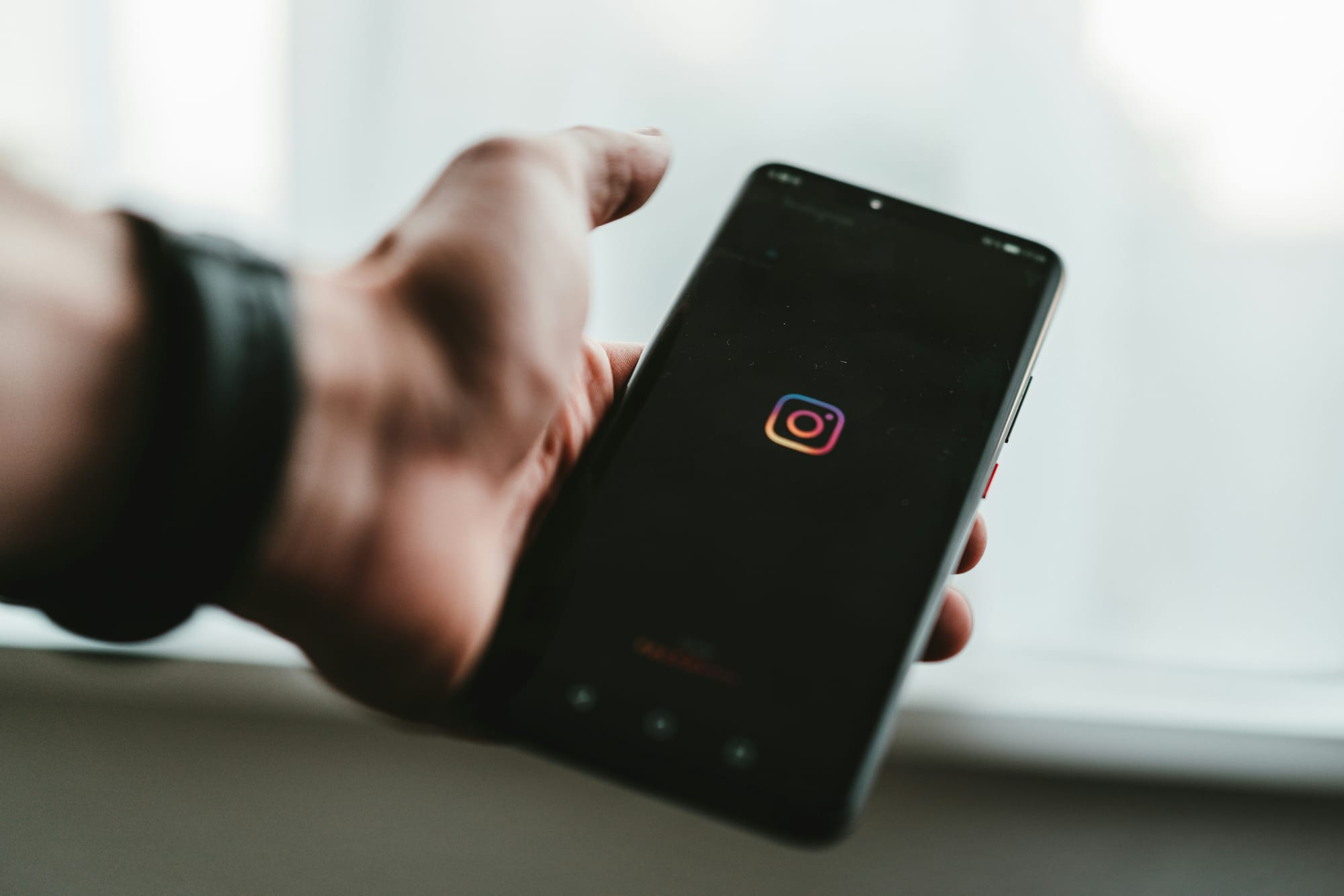 screen showing instagram logo - How to Post Videos on Instagram
