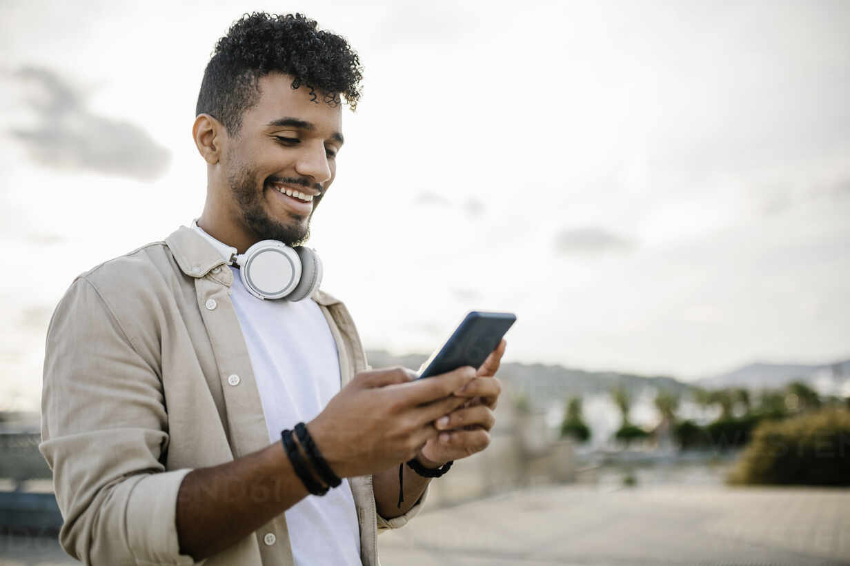 man using white headphones - Best Hashtags for TikTok to Go Viral